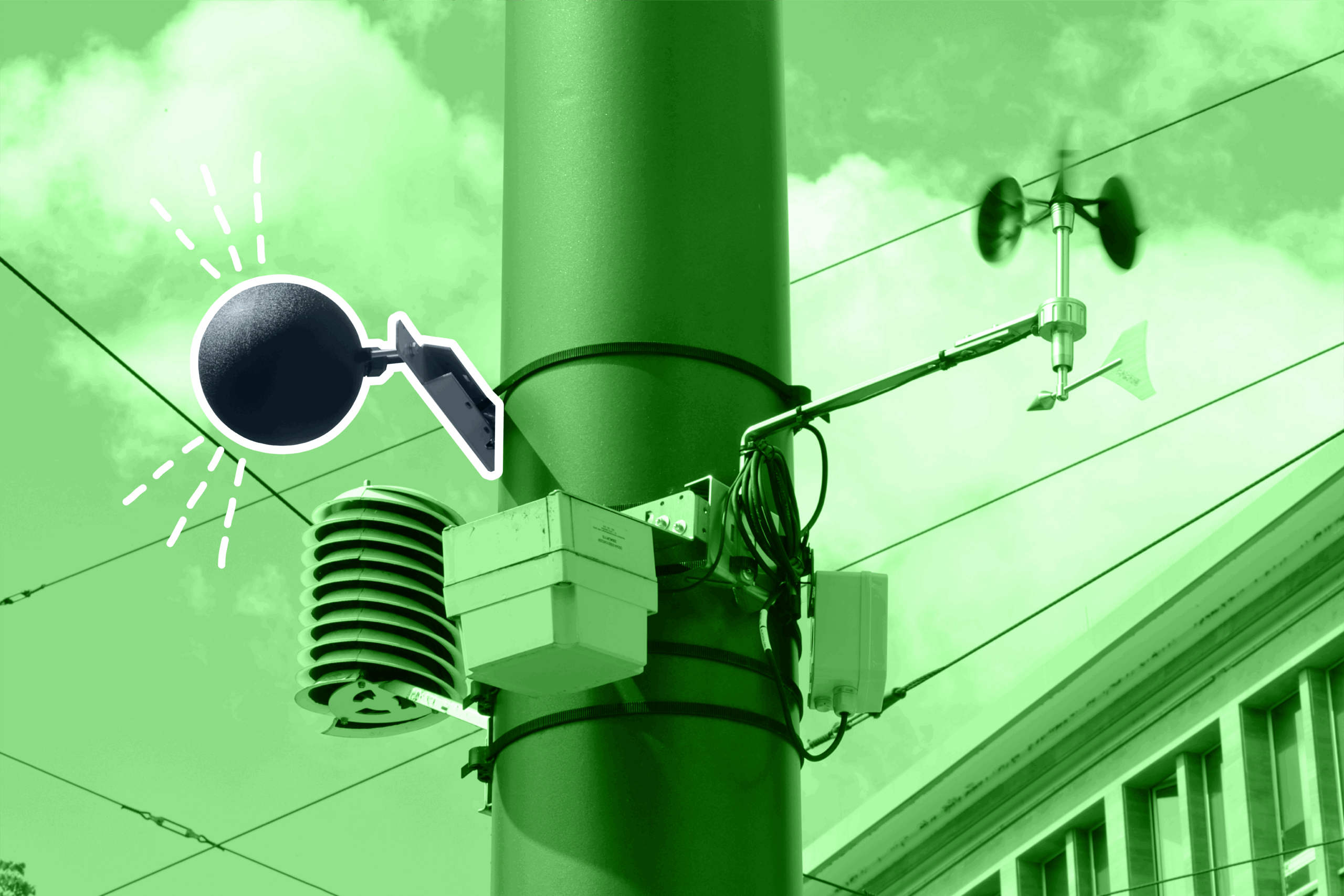 Das Bild zeigt ein Globethermometer zusammen mit einem Windgeber und einer Stahlungsschutzhütte an einem Straßenmast